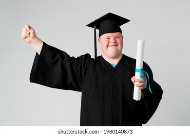 Happy Boy With Down Syndrome In A Graduation Gown