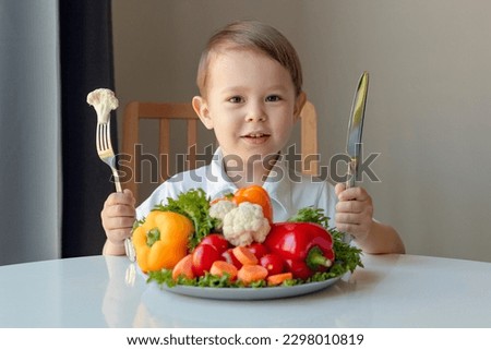 happy boy eating fresh vegetables, healthy eating for kids concept 