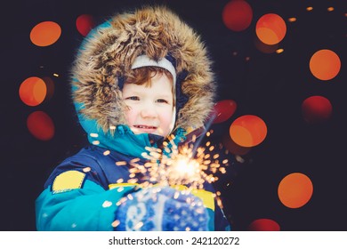 Happy boy with fireworks in his hands. - Powered by Shutterstock