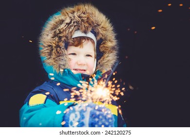 Happy boy with fireworks in his hands. - Powered by Shutterstock