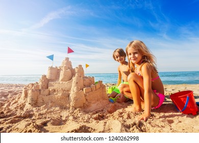 Happy boy and girl playing beach games in summer