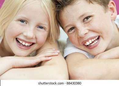 Happy Boy And Girl, Sister And Brother Laughing With Big Toothy Smiles