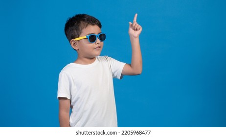 Happy Boy Glasses Blue Background Pointing Stock Photo 2205968477 ...