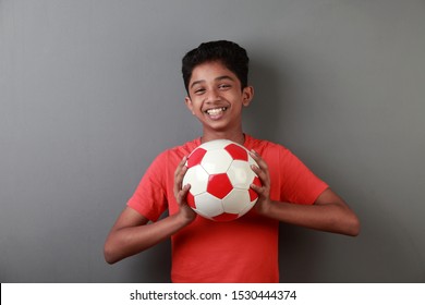 Happy Boy Holds A Soccer Ball In His Hand