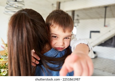 Happy boy hugs his mother at reunion or on his birthday - Shutterstock ID 2251861987