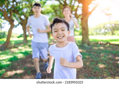 Happy boy  Jogging with parents in the city park - Powered by Shutterstock