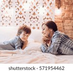 Happy boy with mather near Christmas tree