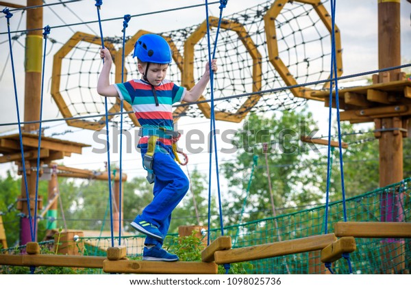 happy boy on the zip line. proud of his\
courage the child in the high wire park.\
HDR