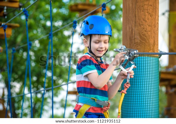 happy boy on the zip line. proud of his\
courage the child in the high wire park.\
HDR