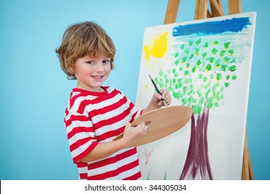 Happy Boy Painting His Picture On An Easel