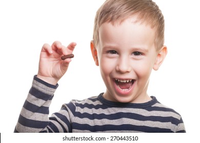 Happy boy with pill on isolated white