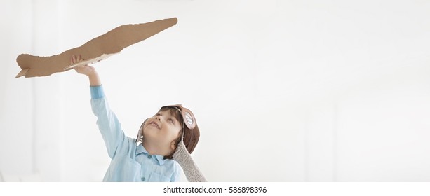 Happy Boy Play With Paper Airplane In Hand, Child Dreams About Traveling By Aeroplane