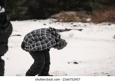 Happy Boy Playing In Snowy Winter Wonderland Snowball Fight