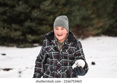 Happy Boy Playing In Snowy Winter Wonderland Snowball Fight