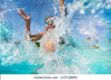 Happy Boy Playing And Splashing In Swimming Pool