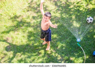 Happy Boy Playing Water Sprinkler Stock Photo (Edit Now) 1066966481