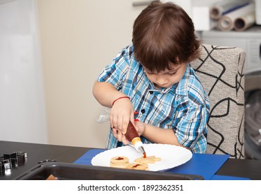 Happy Boy Puts Jam In Cookies