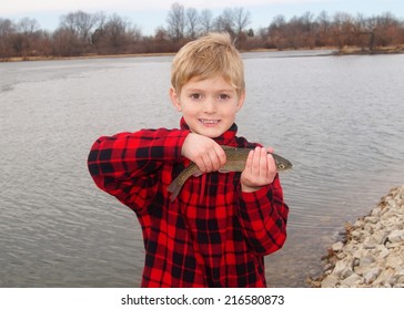 Happy Boy And A Rainbow Trout Fish Caught Fly Fishing At A Lake