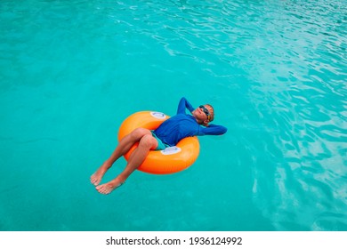 Happy Boy Relax On Floatie In Pool
