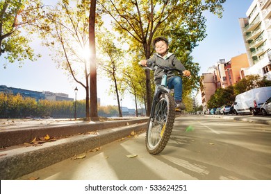 Happy Boy Riding His Bike At City Park