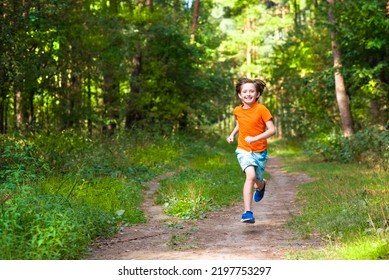 happy boy running through forest in summer - Shutterstock ID 2197753297