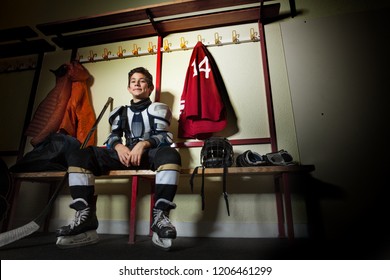 Happy Boy Sitting In Ice Hockey Dressing Room