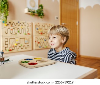A happy boy successfully finished educational toy and learned colors. - Shutterstock ID 2256739219