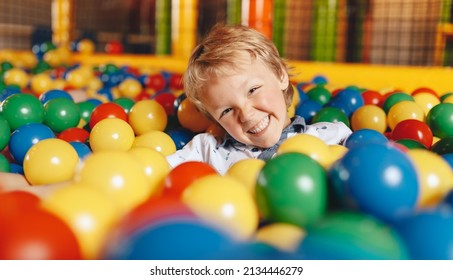 Happy Boy Swimming in a Ball Pit Pool in Amusement Park. Kids Playing and Having Fun at Children Play Centre - Shutterstock ID 2134446279