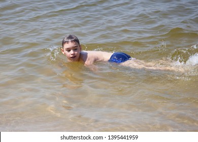 Happy Boy Swimming In The Lake