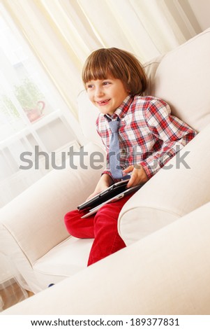 Similar – happy child playing video games with gamepad at home