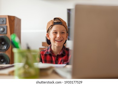 Happy Boy Talking To Someone During A Video Call Over A Computer In The Living Room. 