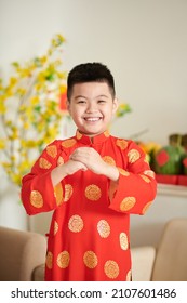 Happy Boy In Traditional Ao Dai Dress Making Greeting Gesture