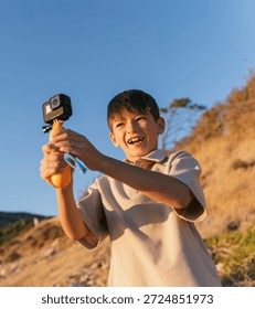 Happy Boy Using Action Camera on Summer Vacation