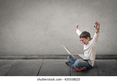 Happy boy using a laptop