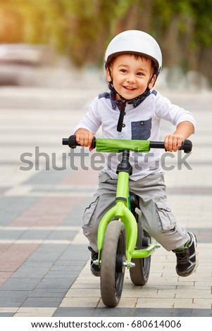 Similar – A funny boy riding his bicycle