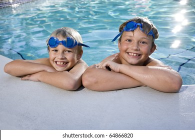 Happy Boys Hanging On Side Of Swimming Pool, 7 And 9 Years