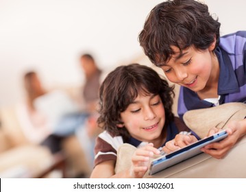 Happy Boys Playing With A Tablet Computer