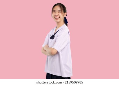 Happy Braces Asian Student Girl In School Uniform Arm Crossed On Isolated Pastel Background.