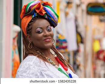 Happy Brazilian woman of African descent dressed in traditional Baiana costumes in the Historic Center of Salvador da Bahia, Brazil. - Shutterstock ID 1582435228