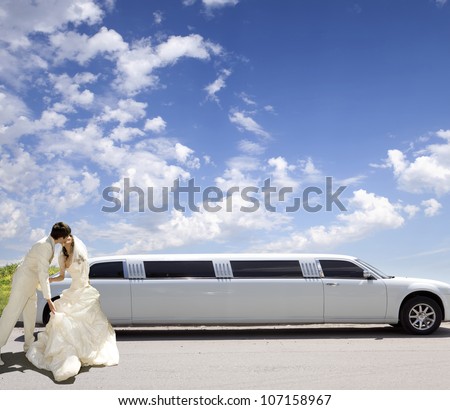 Happy bride and groom about limousine in wedding day