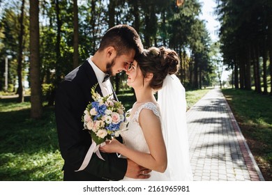 Happy Bride And Groom Looking At Each Other. Portrait Of Lovers