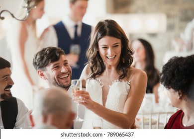 Happy bride and groom are socialising with the guests at their wedding reception. 