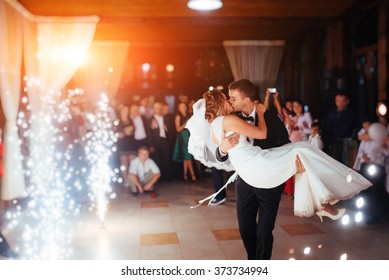 Happy bride and groom and their first dance, wedding in the elegant restaurant with a wonderful light and atmosphere