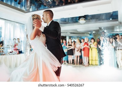 Happy bride and groom and their first dance, wedding in the elegant restaurant with a wonderful light and atmosphere
