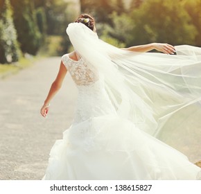 Happy Bride Spinning Around With Veil