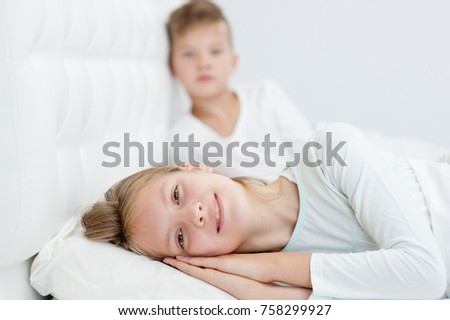 Happy Brother And Sister Lying On Bed Happy Brother And Sister Lying On Bed