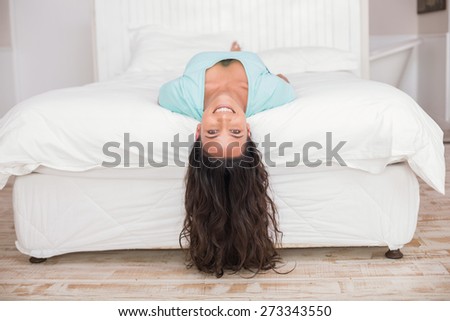 Image, Stock Photo Young woman lying upside down on an armchair