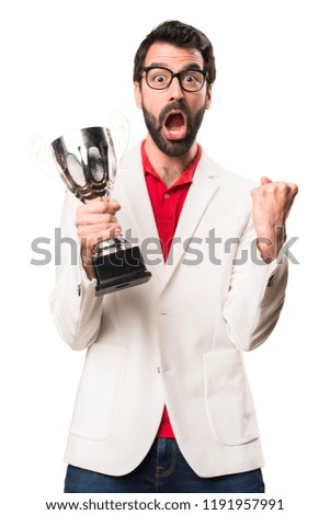 Happy Brunette man with glasses holding a trophy on white background