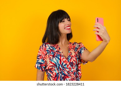 Happy Brunette Woman In Glasses Making Facetime Video Calling With Smartphone At Home, Using Zoom Meeting Online App, Social Distancing, Work From Home, Work Remotely Concept.