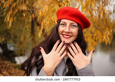 Happy Brunette Woman In Stylish Red Beret, Red Lips And Bordeaux Nails